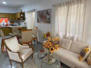 a living room with a couch and chairs and a table at ajmicasita in Constanza