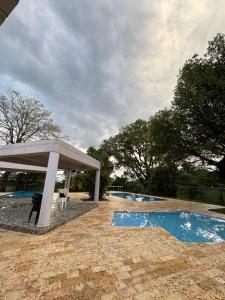 a swimming pool with a gazebo next to a swimming pool at Balcones del Bosque 14 -402 in Restrepo