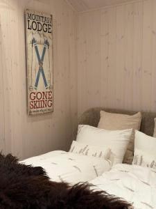 a room with two beds and a sign on the wall at Lyngen Alps Inn in Lyngseidet