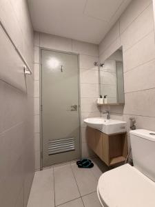 a bathroom with a shower and a toilet and a sink at NeoSkyhigh Suites in Batu Kawan +17 photos