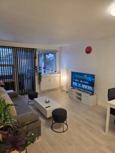 a living room with a large flat screen tv at 2 room apartment in Horsens in Horsens