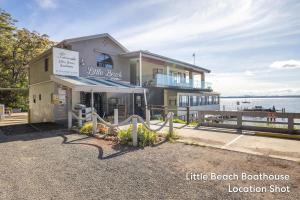 a building with a little beach bookstore location at Promenade 12, 8 Intrepid Cl - fantastic waterfront unit with air con and Wifi in Nelson Bay