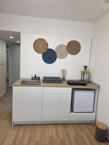 a kitchen with white cabinets and a counter top at Spa & Jacuzzi Dupla Privada Escapadinha Romântica Abrantes in Abrantes