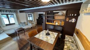 a living room with a table and a couch at Chaloupka za mostem Plavy - Jizerské hory in Plavy