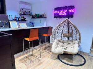 a bar with two chairs and a swing at Hotel Delle Rose in Mestre