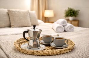 a tray with two cups of coffee on a bed at Bigbass Valencia Centro in Valencia