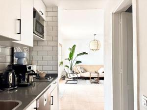a kitchen and living room with a couch at Sabinas place in Corralejo