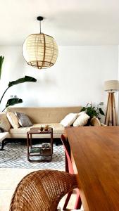 a living room with a couch and a table at Sabinas place in Corralejo +51 photos