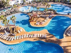 an aerial view of a resort with swimming pools at Sabinas place in Corralejo