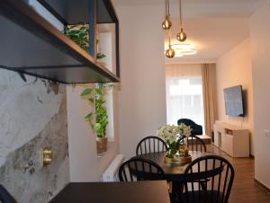 a kitchen and dining room with a table and chairs at Apartament Eleven Międzyzdroje in Międzyzdroje