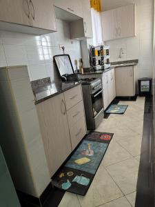 a kitchen with two mats on the floor of a kitchen at Luxx Homes #Unit B in Ruiru