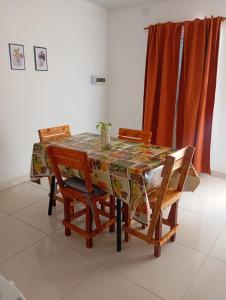 a dining room table with chairs and a table cloth at Dpto Los Pinos in Fernández