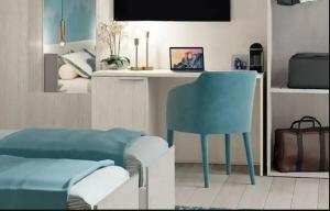a room with a desk and a blue chair at Urban Stay Siena in Siena +1 photo
