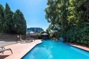 a swimming pool in a yard with trees at Boho by the Bay in Melbourne