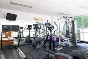 a gym with several treadmills and exercise bikes at Boho by the Bay in Melbourne