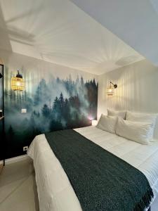 a bedroom with a bed with a painting on the wall at Le Chalet de la Plage in Sévrier +41 photos
