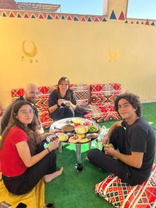 a group of people sitting around a table eating food at NUB Guest House in Aswan +46 photos