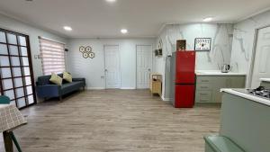 a kitchen with a red refrigerator and a couch at Green House, by Pewma Apart Hotel in Diguillín +14 photos
