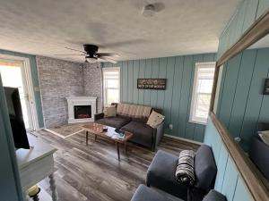 a living room with a couch and a fireplace at Salt Creek Cabin in Chillicothe
