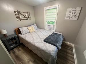a small bedroom with a bed and a window at Salt Creek Cabin in Chillicothe