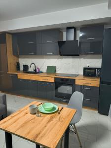 a kitchen with a wooden table with a plate on it at Aura Apartamenty 3 in Brzeg