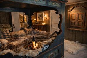 a bedroom with a large bed with candles on it at Traditional timber farm with Sauna & Wi-Fi in Baukål +43 photos