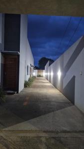 a row of white buildings with lights on the side at loft - studio excelente localização! in São Félix do Xingu