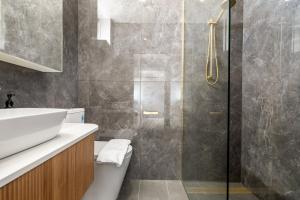 a bathroom with a sink and a shower at Modern refine home in Bellerive +11 photos