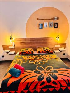 a bedroom with a large bed with two pillows at Airport Pamatai Room in Faaa