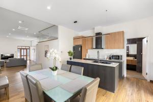 a kitchen and dining room with a table and chairs at Modern refine home in Bellerive