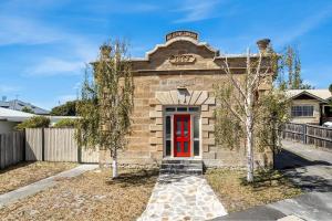 a brick building with a red door at Modern refine home in Bellerive