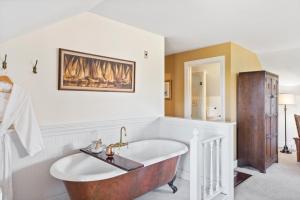 a bathroom with a large tub and a sink at Ravenscroft Inn in Port Townsend +33 photos