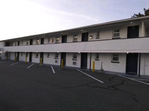 an empty parking lot in front of a building at Budget Inn in Somers Point