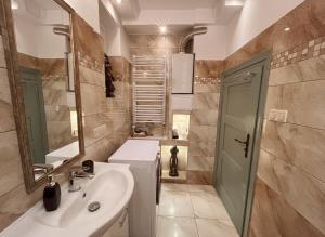 a bathroom with a sink and a mirror at Gawra Bogusza in Lądek-Zdrój