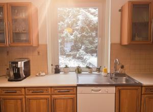 a kitchen with a sink and a window at Gawra Bogusza in Lądek-Zdrój +17 photos