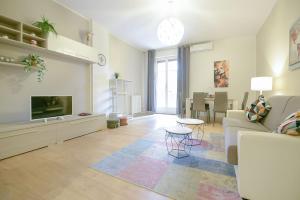 a living room with a couch and a tv at Ak Holidays Apartment 59 in Bologna