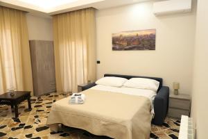 a hotel room with two beds and a table at Paradiso dell'Etna in Zafferana Etnea
