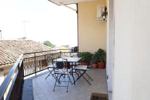 a patio with a table and chairs on a balcony at Paradiso dell'Etna in Zafferana Etnea