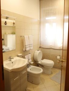 a bathroom with a toilet and a sink at Paradiso dell'Etna in Zafferana Etnea +18 photos