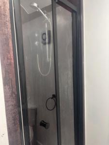 a shower in a bathroom with a glass door at Idan House in Llanberis +36 photos