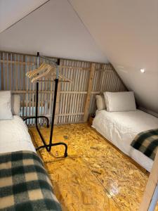 a room with two beds in a room with a wall at Stable Lodge in Killarney