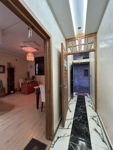 a hallway with a blue door in a room at Breeze surf lodge in Tamraght Ouzdar