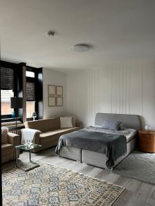 a bedroom with a bed and a couch at Domblick Apartment in Aachen