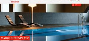 a swimming pool with two chairs and a lamp at Naschpark Dream Apartments! in Vienna