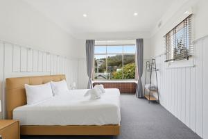 a bedroom with a large bed and a window at Charming Sandy Bay Stay in Sandy Bay