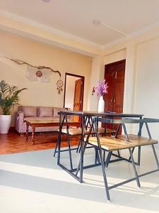 a glass table in a living room with a couch at The Himalayan Homes in Tokna