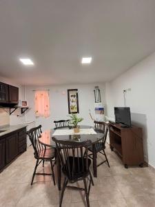 a kitchen and dining room with a table and chairs at Edificio LUMARO in San Fernando del Valle de Catamarca