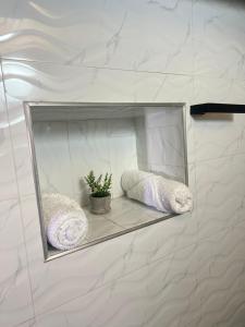 a mirror on a wall with two pillows and a plant at Finca el Paraíso de Monguí in Monguí +38 photos