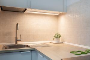 a kitchen with a sink and a faucet at BRiKS Airport Stay Caselle in Caselle Torinese