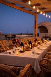 a long table with candles and lights on it at Soléi Desert Retreat in Siwa